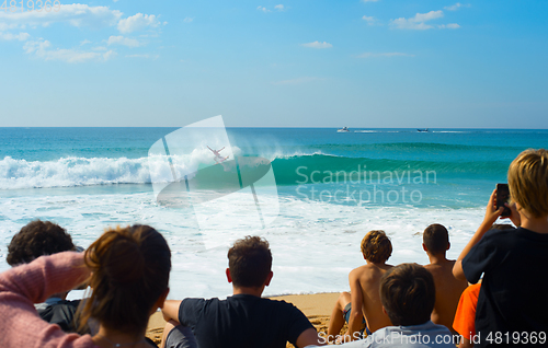 Image of People watching surfing contest beach