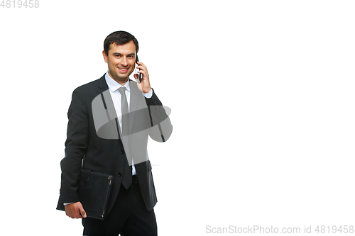 Image of handsome businessman in suit talking on phone