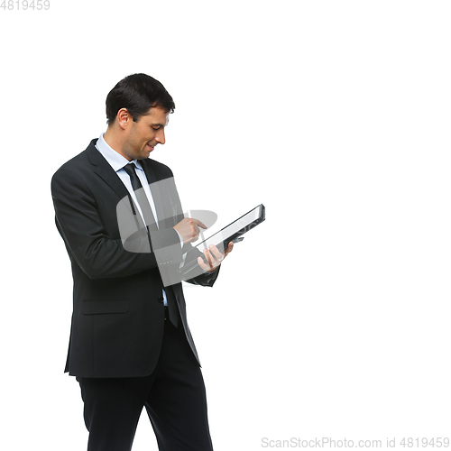 Image of handsome businessman in suit with tablet