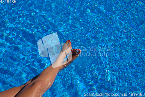 Image of woman\'s feet touching water