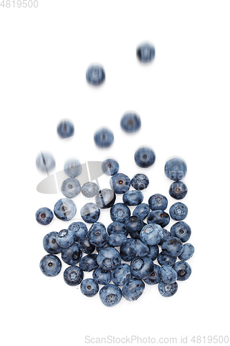 Image of falling blueberry berries isolated on white background