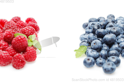 Image of blueberry and raspberry berries isolated on white background