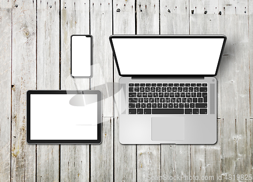 Image of Laptop, tablet and phone set mockup on a wooden background. 3D r