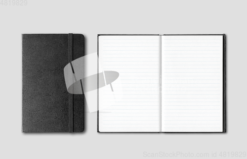 Image of Black closed and open notebooks isolated on grey