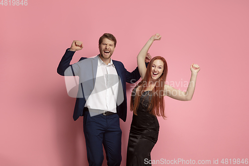 Image of Valentine\'s day celebration, happy caucasian couple isolated on coral background