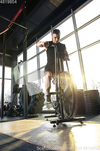 Image of The male athlete training hard in the gym. Fitness and healthy life concept.