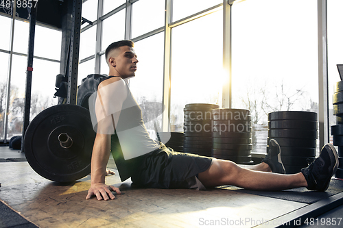 Image of The male athlete training hard in the gym. Fitness and healthy life concept.