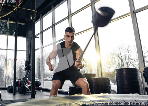 Image of The male athlete training hard in the gym. Fitness and healthy life concept.