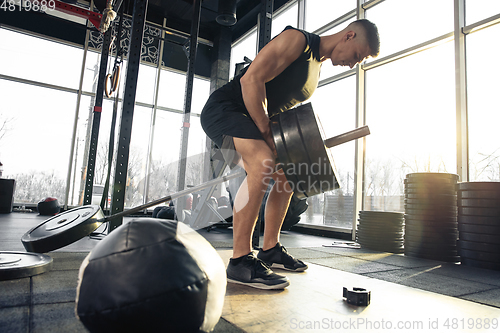 Image of The male athlete training hard in the gym. Fitness and healthy life concept.
