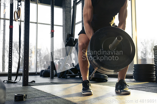 Image of The male athlete training hard in the gym. Fitness and healthy life concept.