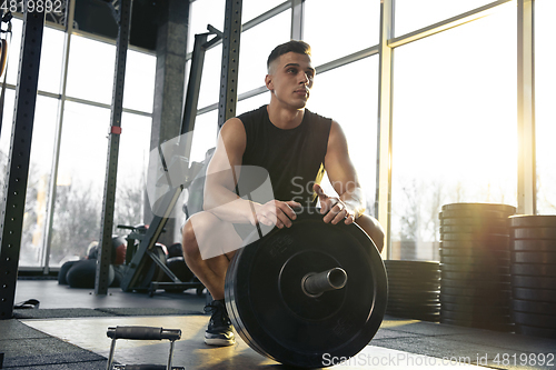 Image of The male athlete training hard in the gym. Fitness and healthy life concept.