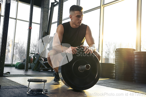 Image of The male athlete training hard in the gym. Fitness and healthy life concept.