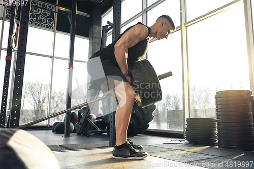 Image of The male athlete training hard in the gym. Fitness and healthy life concept.