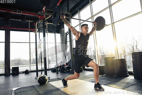 Image of The male athlete training hard in the gym. Fitness and healthy life concept.