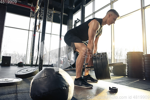 Image of The male athlete training hard in the gym. Fitness and healthy life concept.