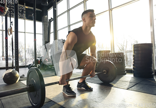 Image of The male athlete training hard in the gym. Fitness and healthy life concept.