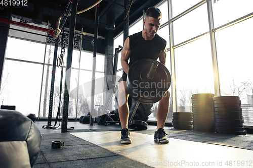 Image of The male athlete training hard in the gym. Fitness and healthy life concept.