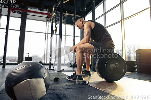 Image of The male athlete training hard in the gym. Fitness and healthy life concept.