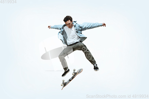 Image of Caucasian young skateboarder riding isolated on a white background