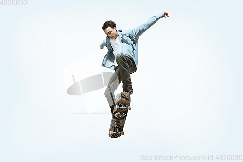 Image of Caucasian young skateboarder riding isolated on a white background