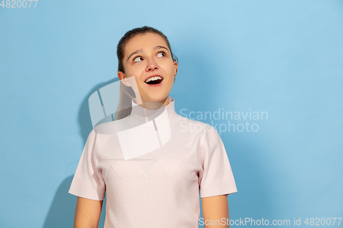 Image of Caucasian teen girl portrait isolated on blue studio background