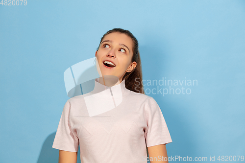 Image of Caucasian teen girl portrait isolated on blue studio background