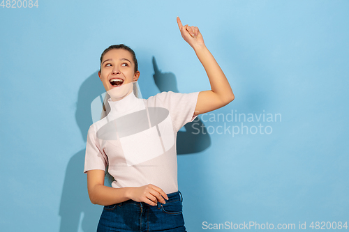 Image of Caucasian teen girl portrait isolated on blue studio background