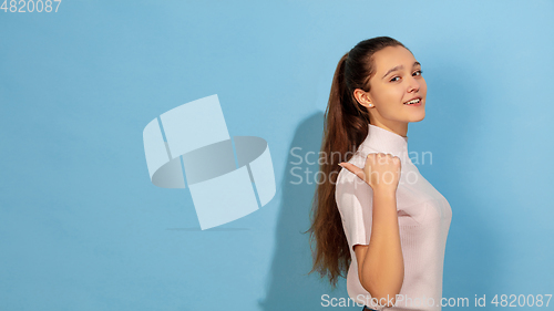 Image of Caucasian teen girl portrait isolated on blue studio background