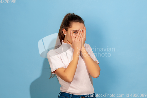 Image of Caucasian teen girl portrait isolated on blue studio background