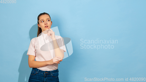 Image of Caucasian teen girl portrait isolated on blue studio background