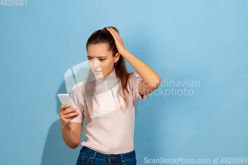 Image of Caucasian teen girl portrait isolated on blue studio background