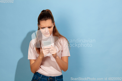 Image of Caucasian teen girl portrait isolated on blue studio background