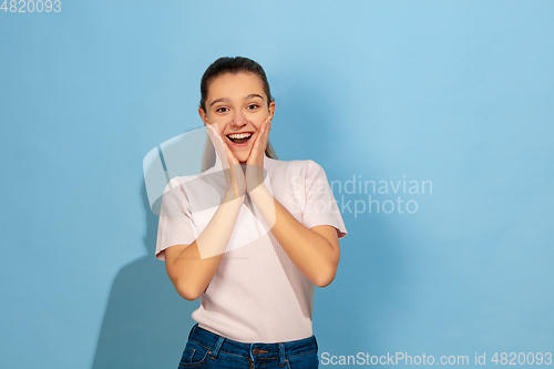 Image of Caucasian teen girl portrait isolated on blue studio background