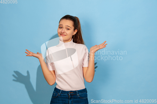 Image of Caucasian teen girl portrait isolated on blue studio background