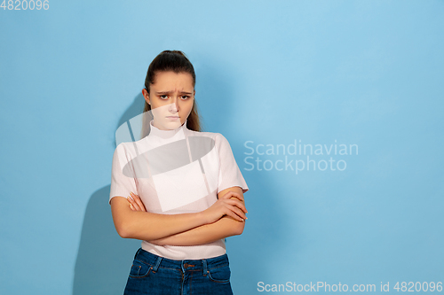 Image of Caucasian teen girl portrait isolated on blue studio background