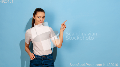 Image of Caucasian teen girl portrait isolated on blue studio background