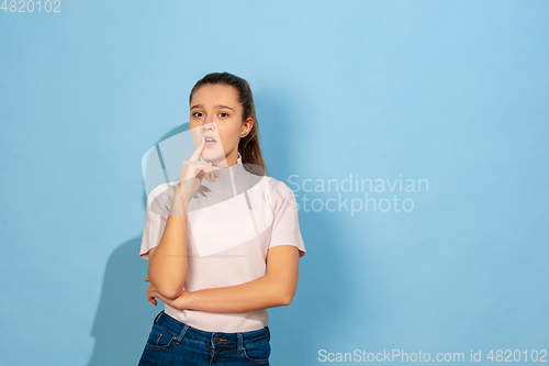 Image of Caucasian teen girl portrait isolated on blue studio background
