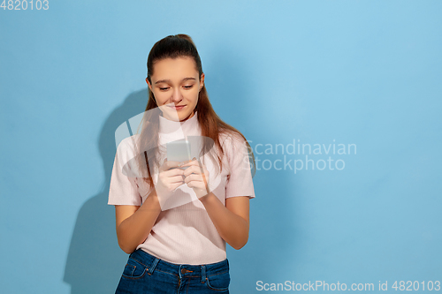 Image of Caucasian teen girl portrait isolated on blue studio background