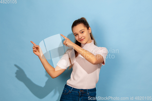 Image of Caucasian teen girl portrait isolated on blue studio background