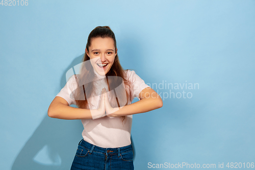 Image of Caucasian teen girl portrait isolated on blue studio background