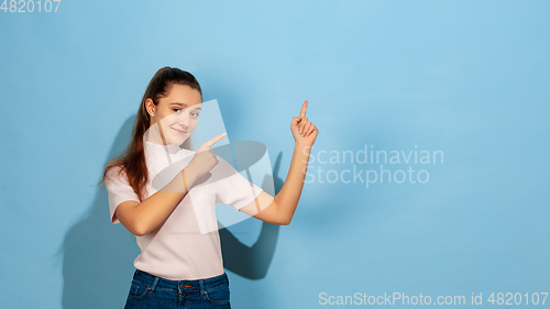 Image of Caucasian teen girl portrait isolated on blue studio background