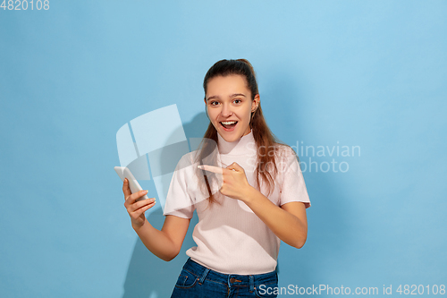 Image of Caucasian teen girl portrait isolated on blue studio background