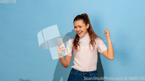 Image of Caucasian teen girl portrait isolated on blue studio background