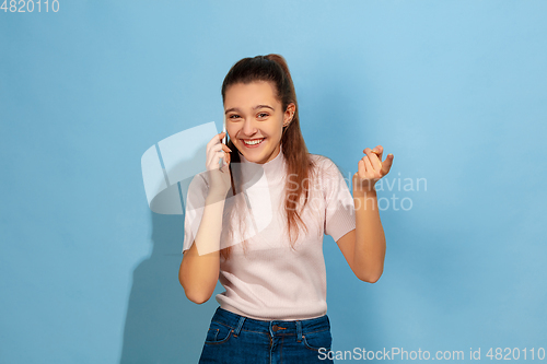 Image of Caucasian teen girl portrait isolated on blue studio background