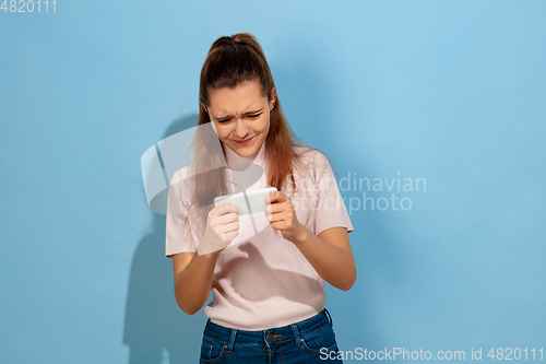 Image of Caucasian teen girl portrait isolated on blue studio background