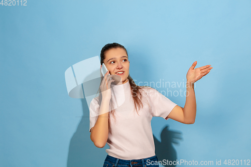 Image of Caucasian teen girl portrait isolated on blue studio background