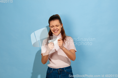 Image of Caucasian teen girl portrait isolated on blue studio background