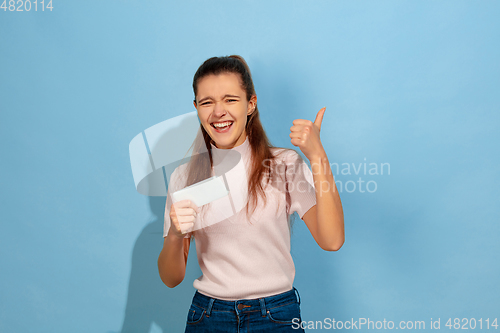 Image of Caucasian teen girl portrait isolated on blue studio background