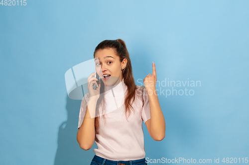 Image of Caucasian teen girl portrait isolated on blue studio background