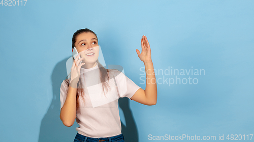 Image of Caucasian teen girl portrait isolated on blue studio background